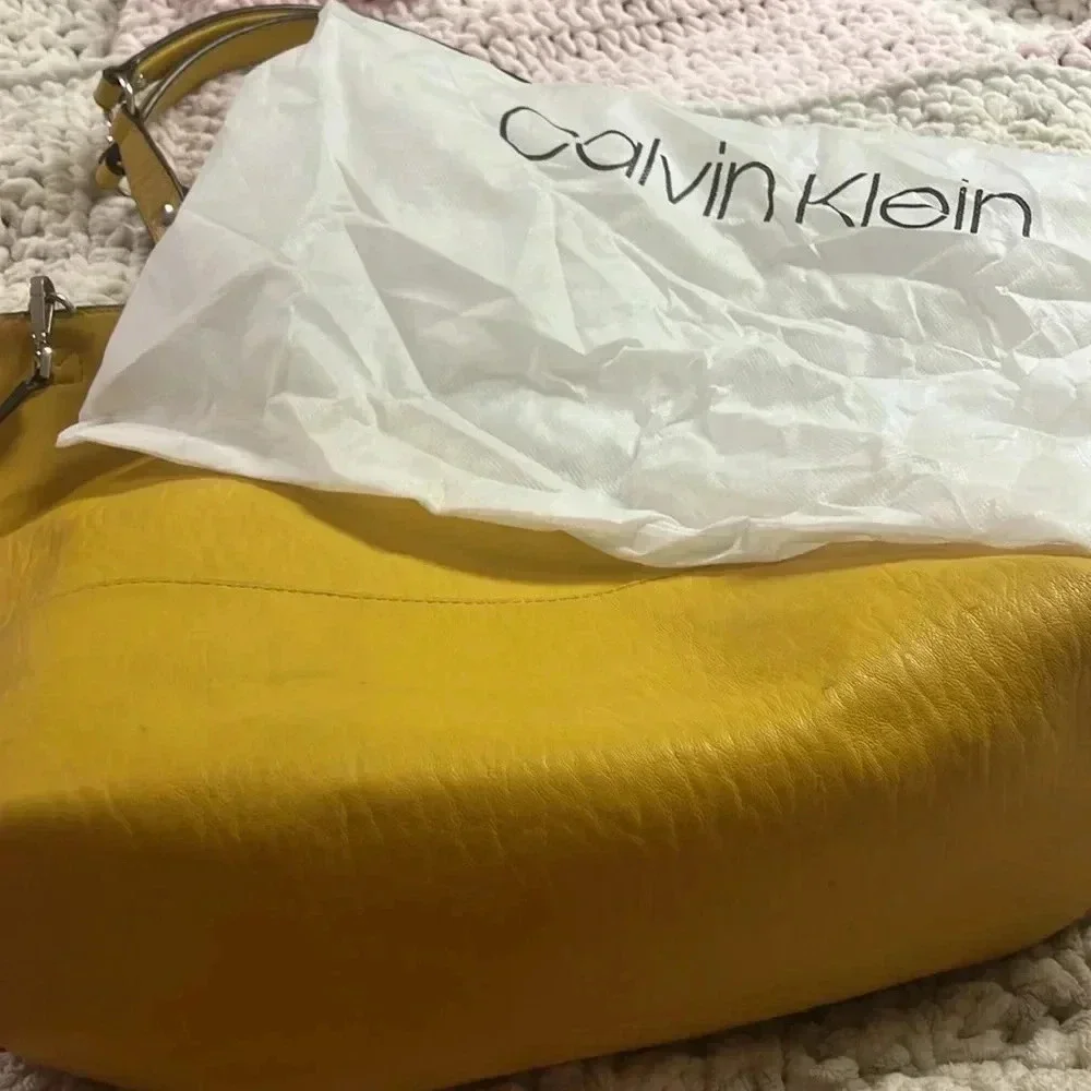Calvin Klein few spots well loved pvc material.